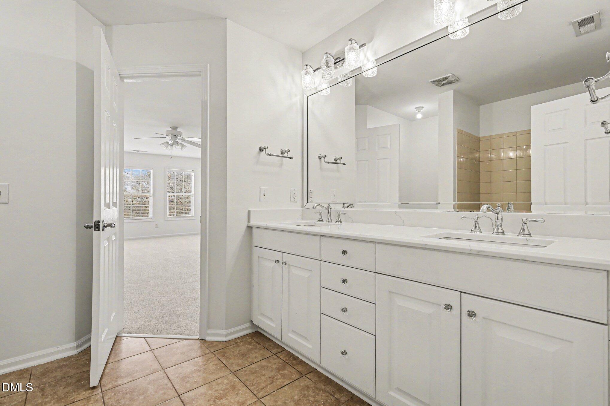 723 Swan Neck Lane Raleigh, NC 27615 - Photo 34 of 52 a bathroom with a granite countertop sink mirror and double