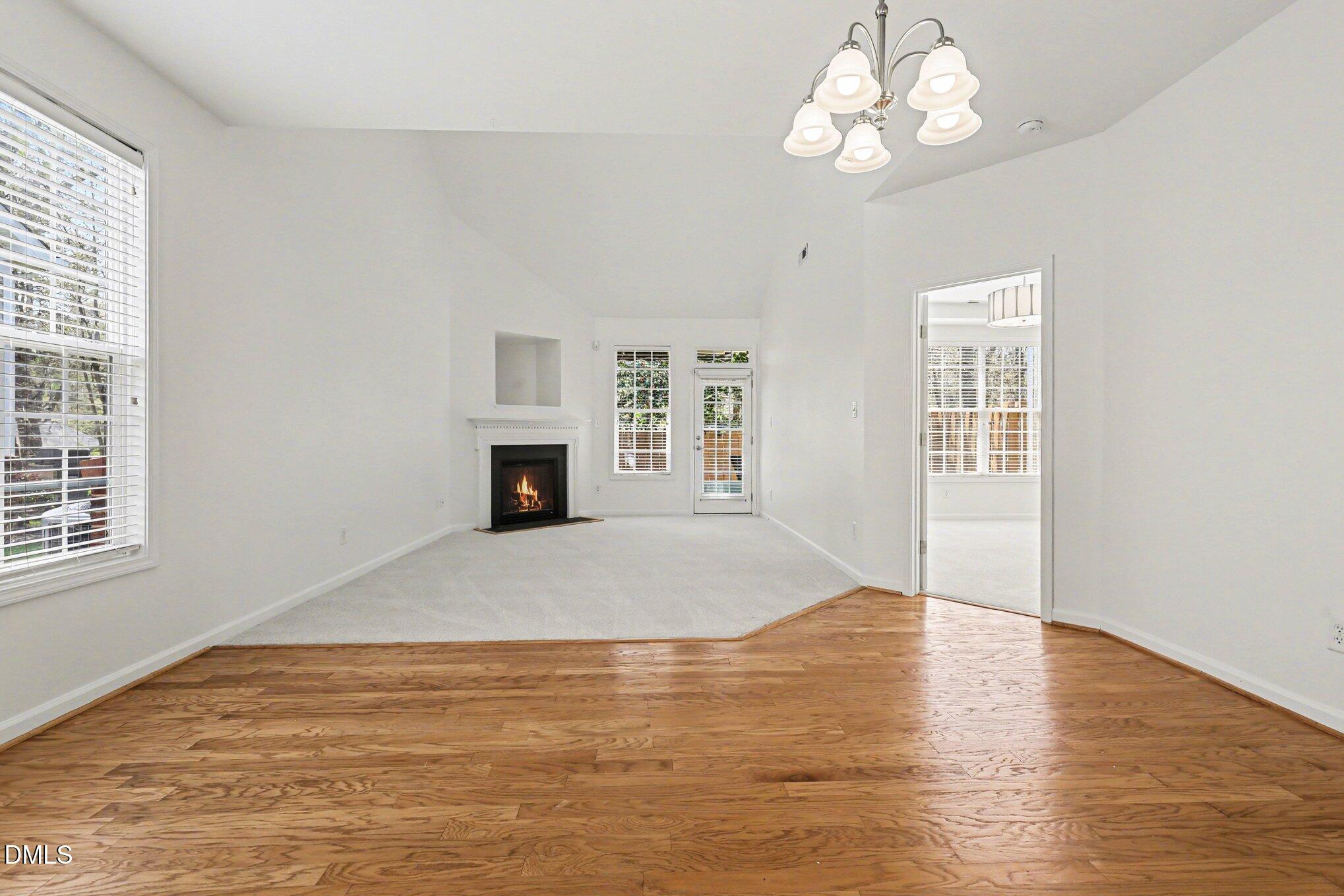723 Swan Neck Lane Raleigh, NC 27615 - Photo 4 of 52 a view of an empty room with wooden floor and a window