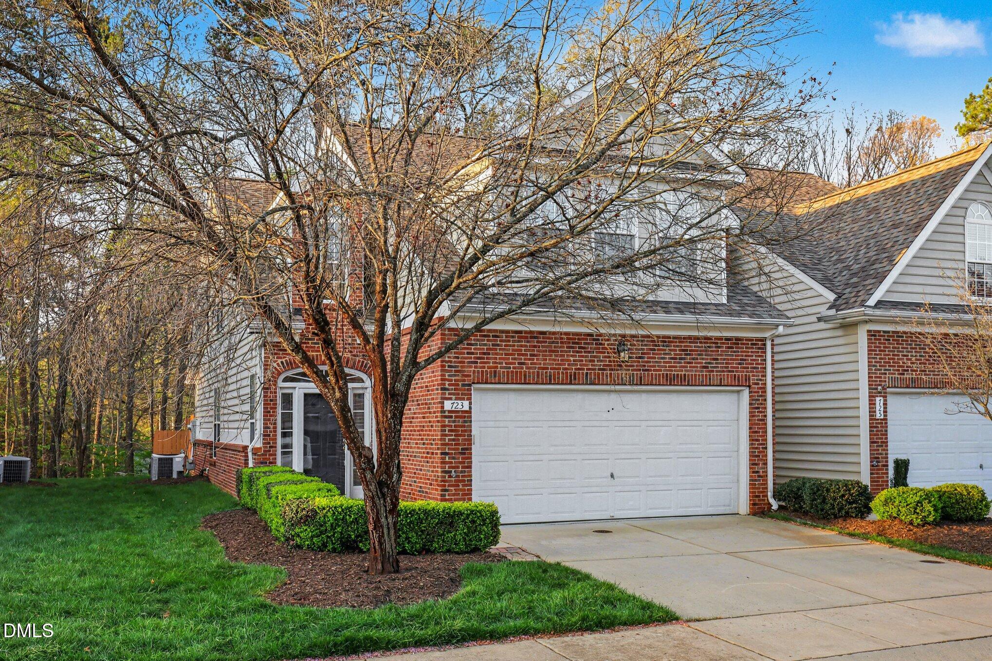 723 Swan Neck Lane Raleigh, NC 27615 - Photo 48 of 52 a front view of a house with a yard and garage