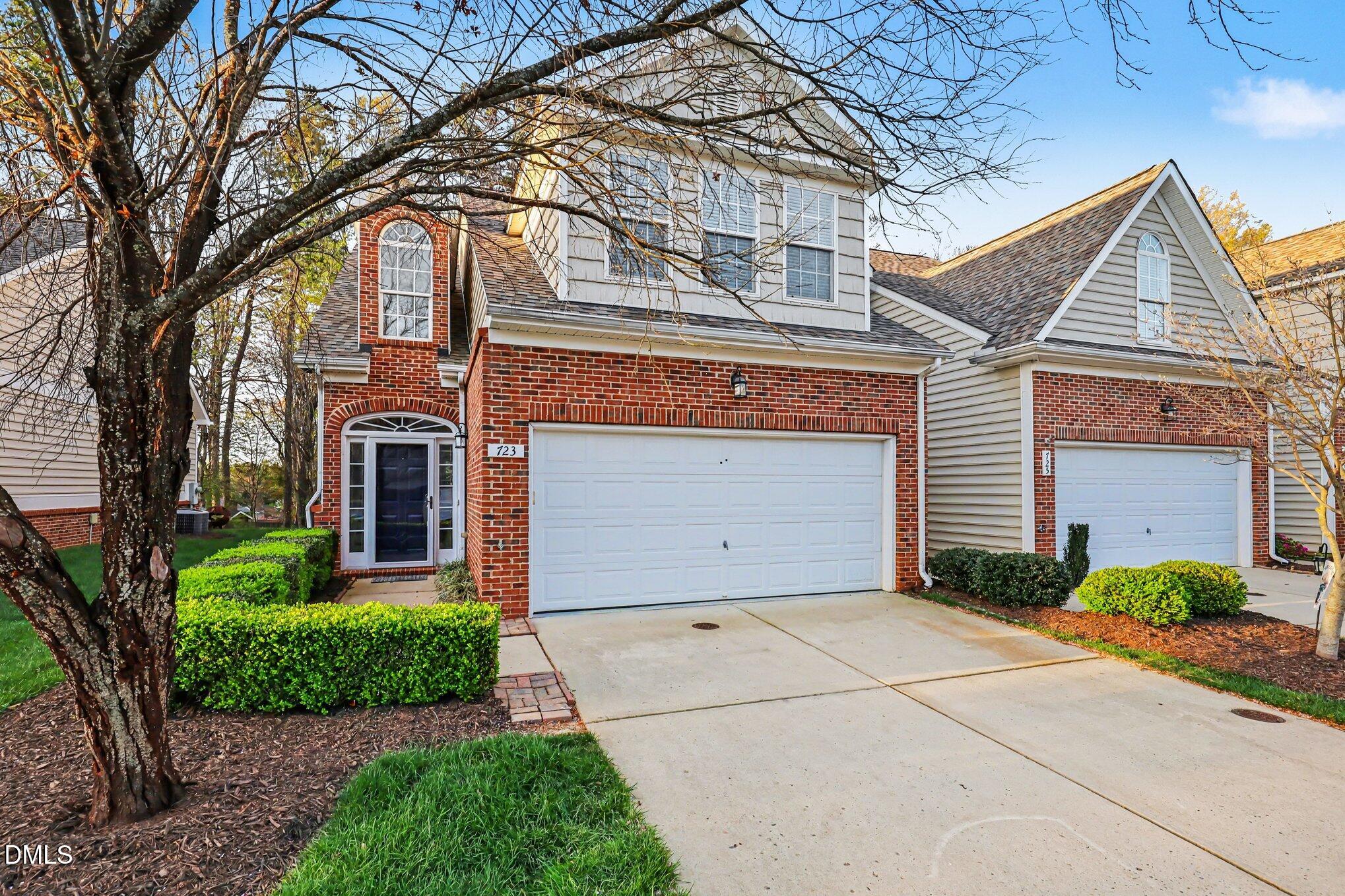 723 Swan Neck Lane Raleigh, NC 27615 - Photo 49 of 52 a front view of a house with garden