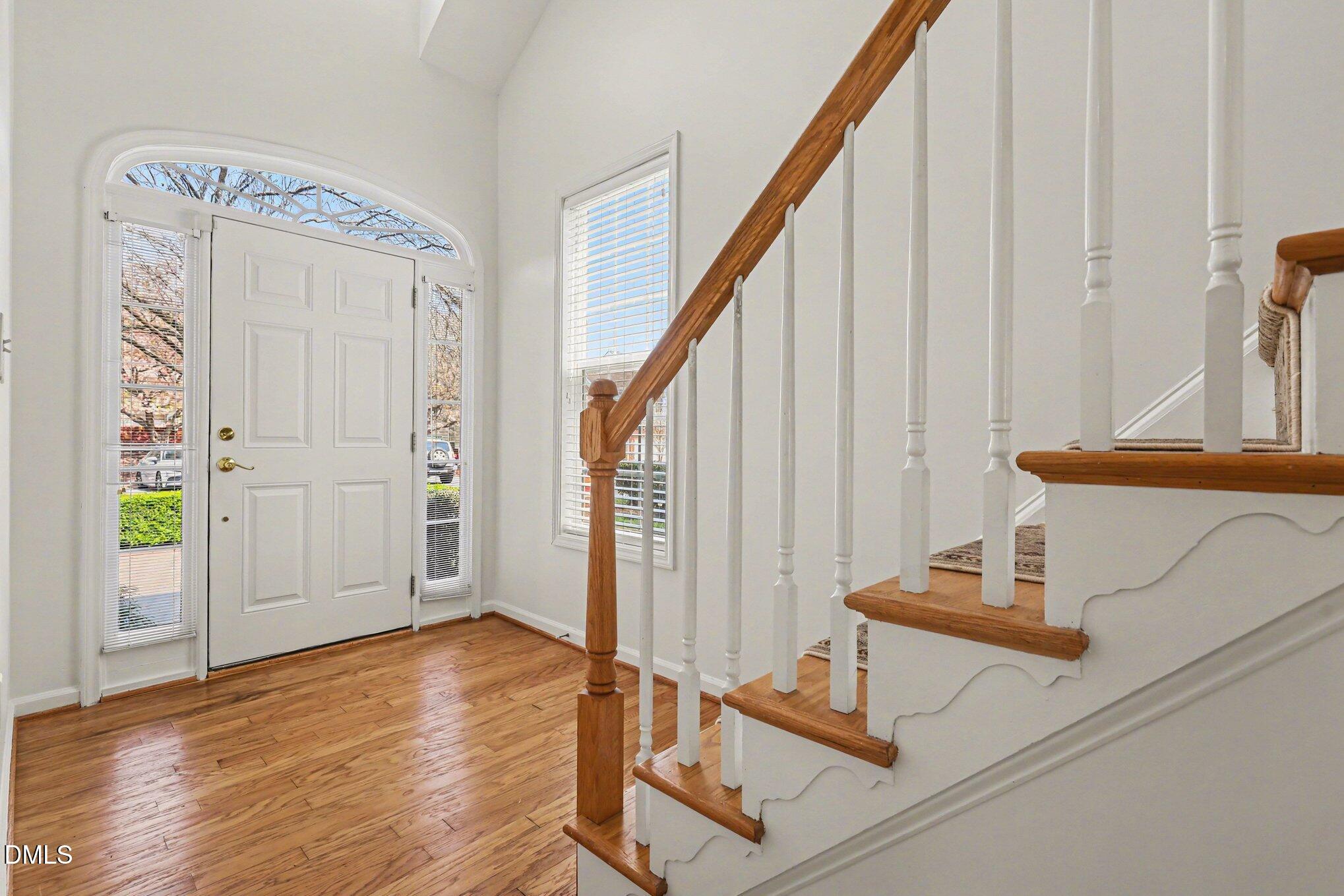 723 Swan Neck Lane Raleigh, NC 27615 - Photo 7 of 52 a view of a hallway with wooden floor and staircase