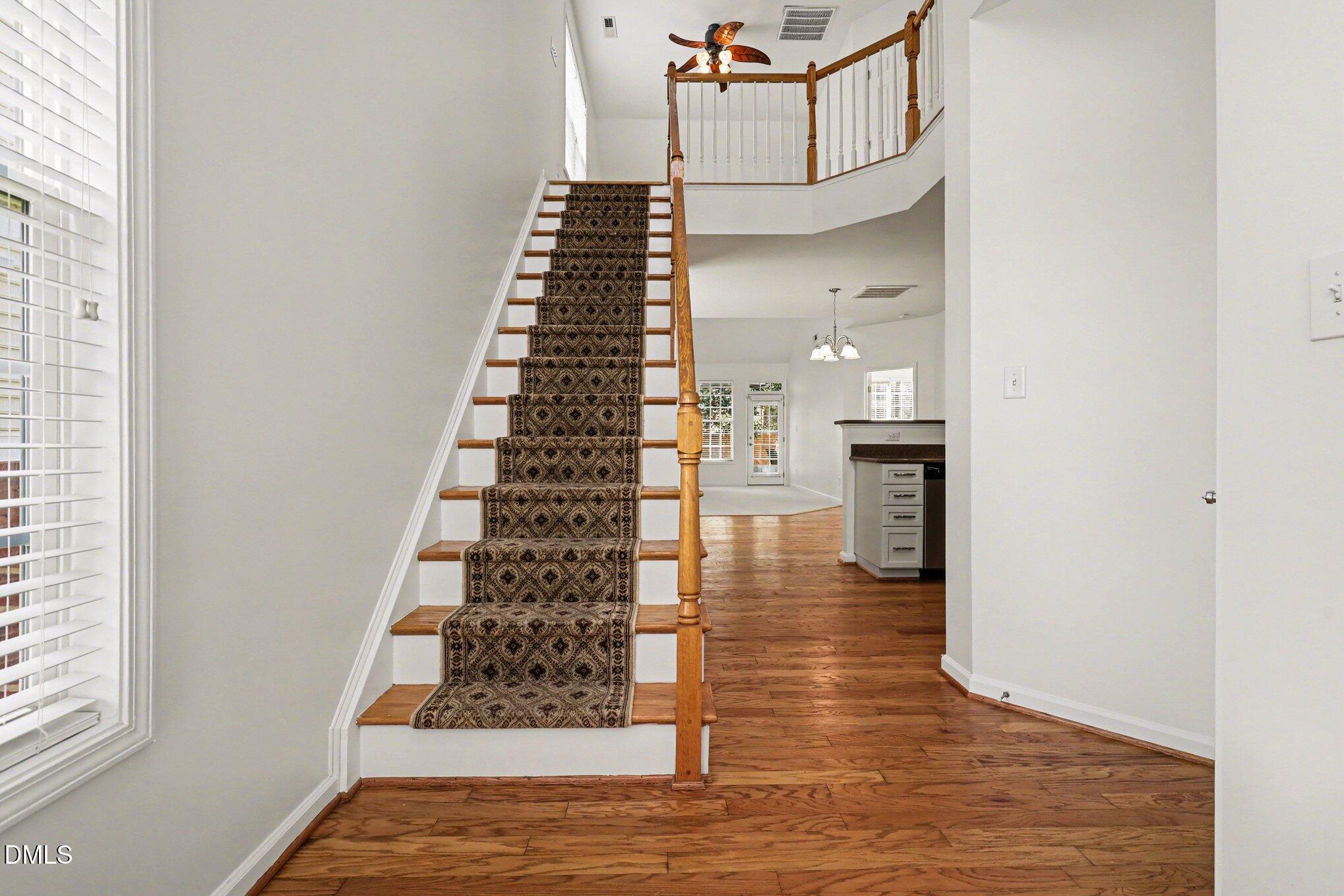723 Swan Neck Lane Raleigh, NC 27615 - Photo 8 of 52 a view of entryway and hall with wooden floor