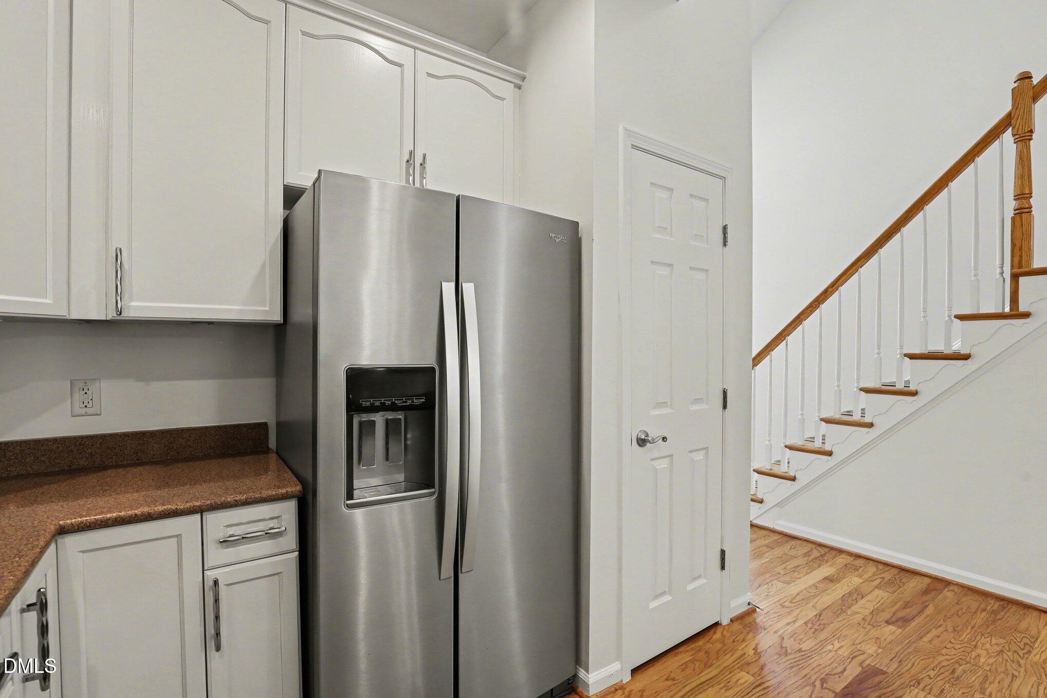723 Swan Neck Lane Raleigh, NC 27615 - Photo 9 of 52 a kitchen with stainless steel appliances a refrigerator and cabinets