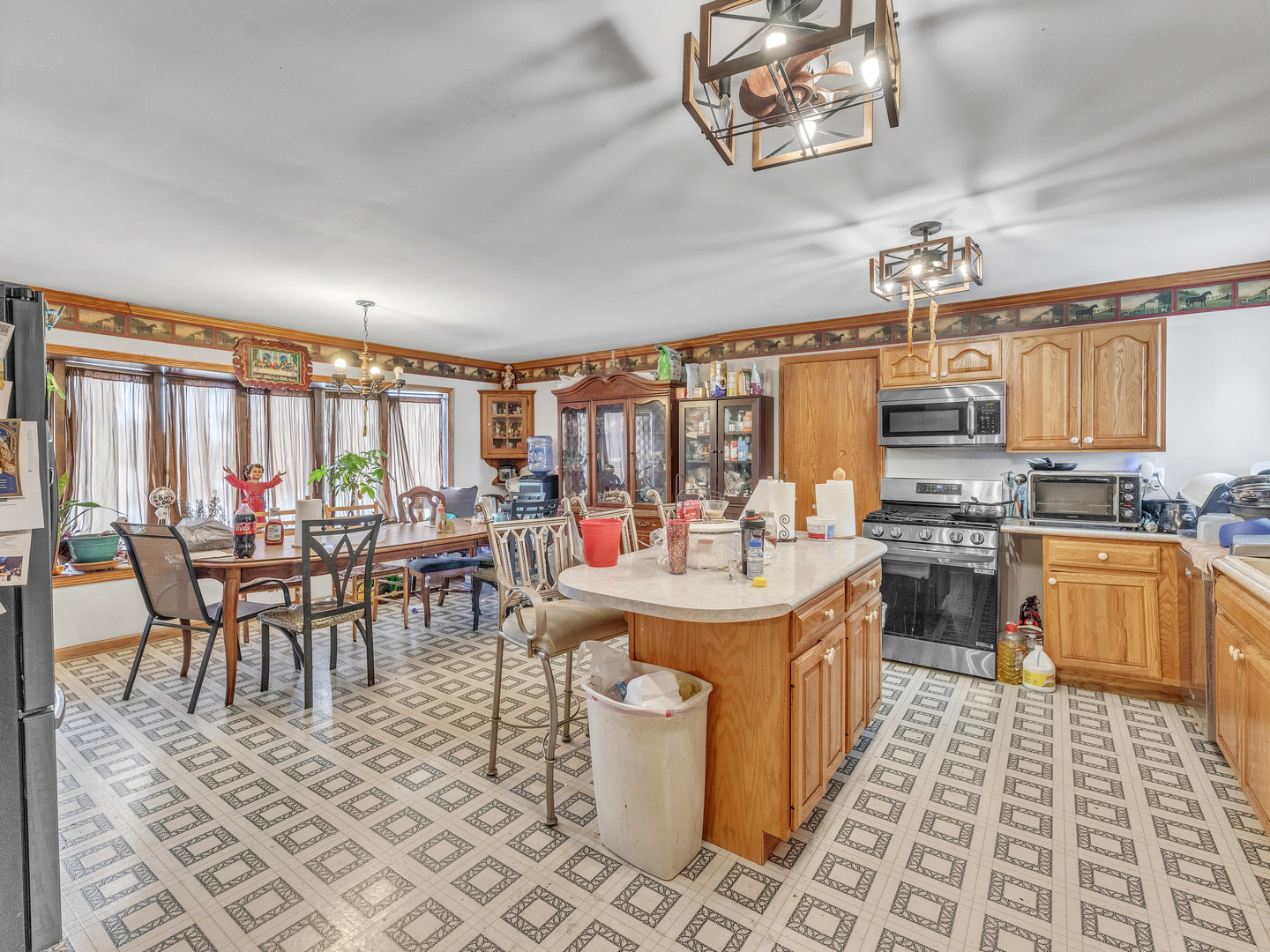 29153 South Klemme Road Beecher, IL 60401 - Photo 6 of 54 a large kitchen with a table chairs stove and cabinets