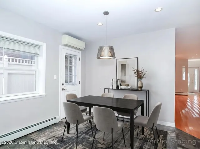 a dining room with furniture and window