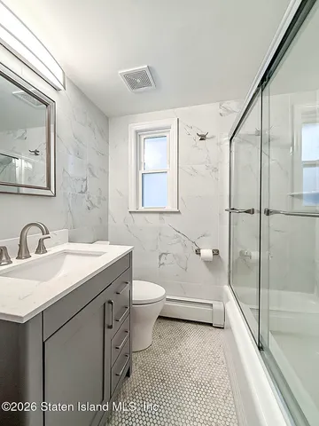 a view of a bathroom with bathtub and shower