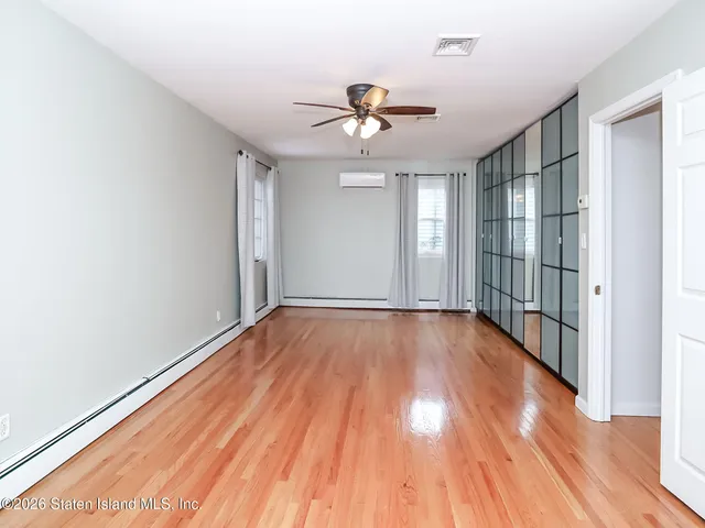 a bedroom with a bed chandelier and a window
