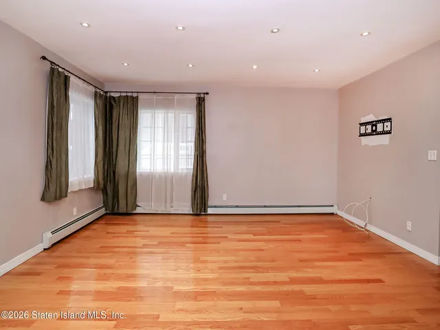 a view of an empty room with glass door