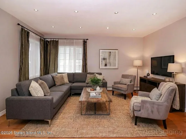 a living room with furniture and a flat screen tv