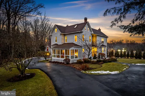 a front view of a house with yard and green space