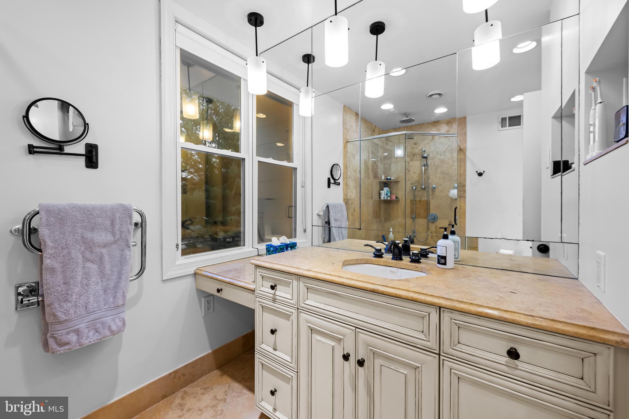 8412 Stevenson Road Baltimore, MD 21208 - Photo 46 of 77 a bathroom with a sink double vanity and a shower