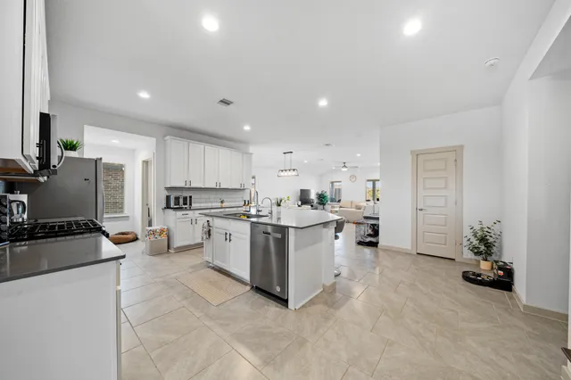 a kitchen with a sink cabinets and stainless steel appliances