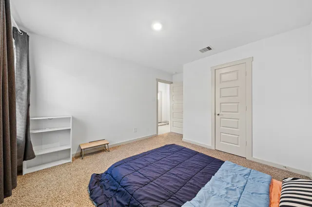 a bedroom with a bed and a dresser