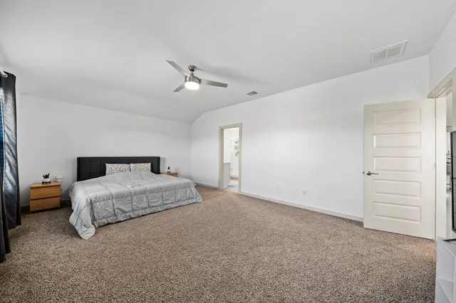 a spacious bedroom with a bed and closet