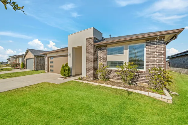 a front view of house with yard and outdoor seating