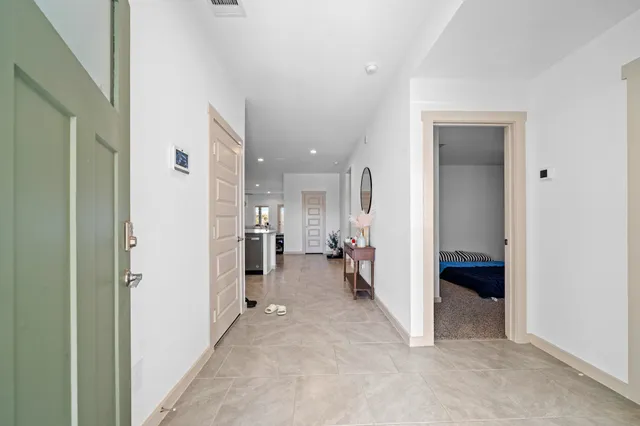 a view of a hallway with furniture and a living room