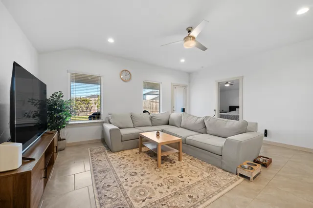 a living room with furniture and a large window