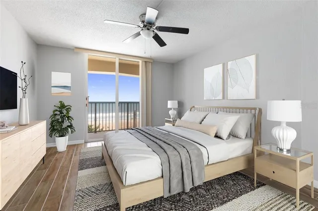 a view of an empty room with wooden floor and windows