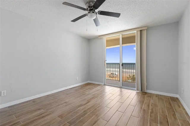 a bathroom with a granite countertop sink a toilet and mirror