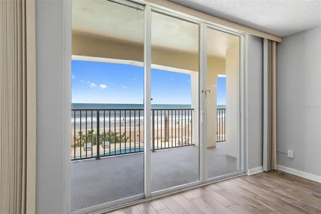 a view of a kitchen with refrigerator and a sink