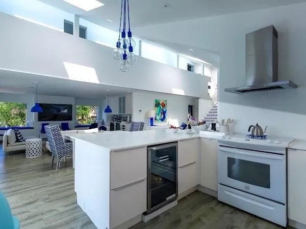 a kitchen with a stove cabinets and wooden floor