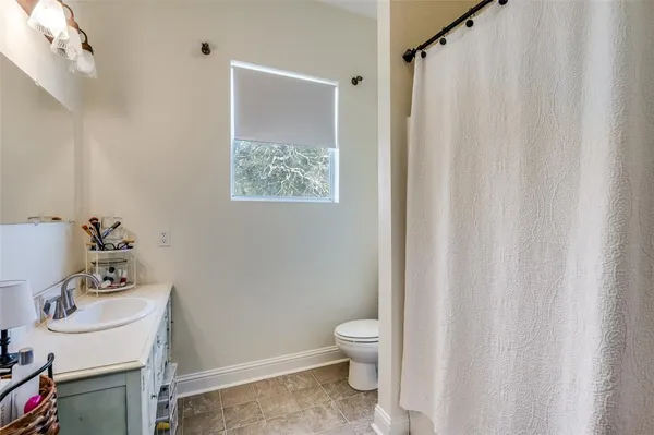 a white toilet sitting next to a bathroom sink