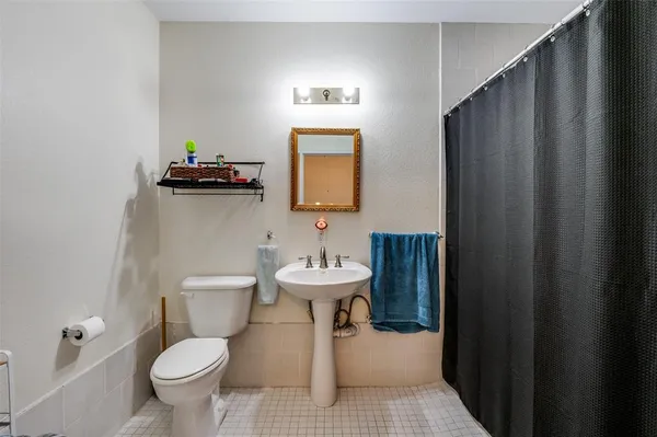 a bathroom with a sink a toilet and mirror