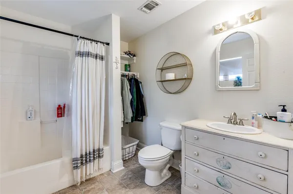 a bathroom with a toilet a sink and a mirror
