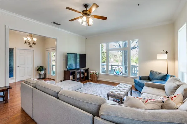 a living room with furniture a large window and a flat screen tv