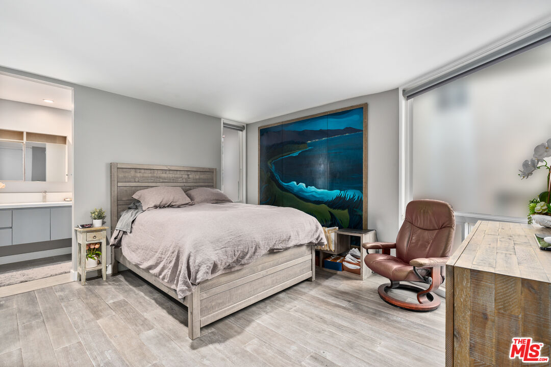 6 Fleet Street, Unit 203 Marina del Rey, CA 90292 - Photo 14 of 25 a bedroom with a bed and a chair