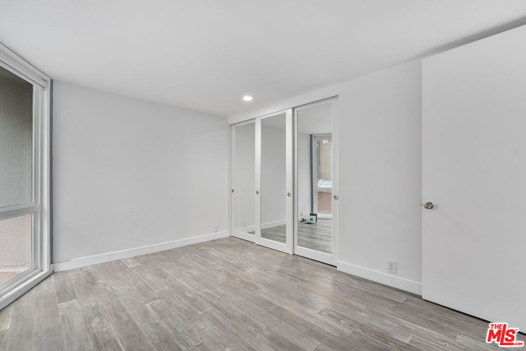 6 Fleet Street, Unit 203 Marina del Rey, CA 90292 - Photo 19 of 25 a view of room with walk in closet and wooden floor