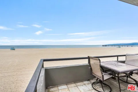 a roof deck with a table and chairs