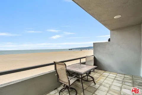 a balcony with a table and chairs