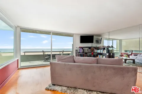 a living room with couches and a flat screen tv