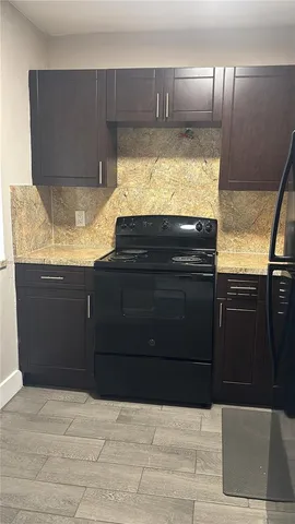 a kitchen with granite countertop stainless steel appliances and cabinets