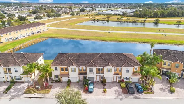an aerial view of residential houses with yard and ocean view