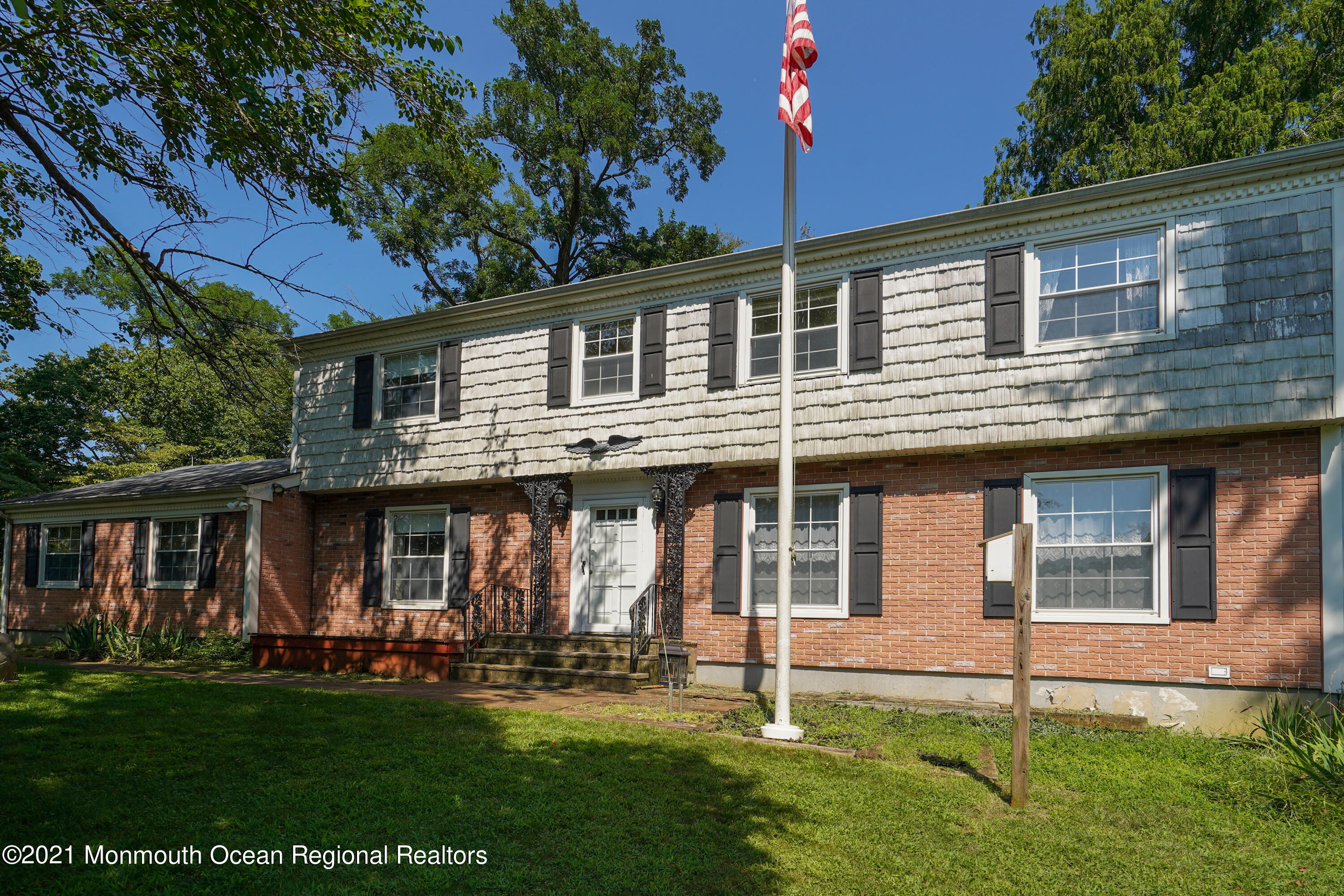 32 Beaver Dam Road Colts Neck, NJ 07722 - Photo 1 of 27 a front view of a house with a garden