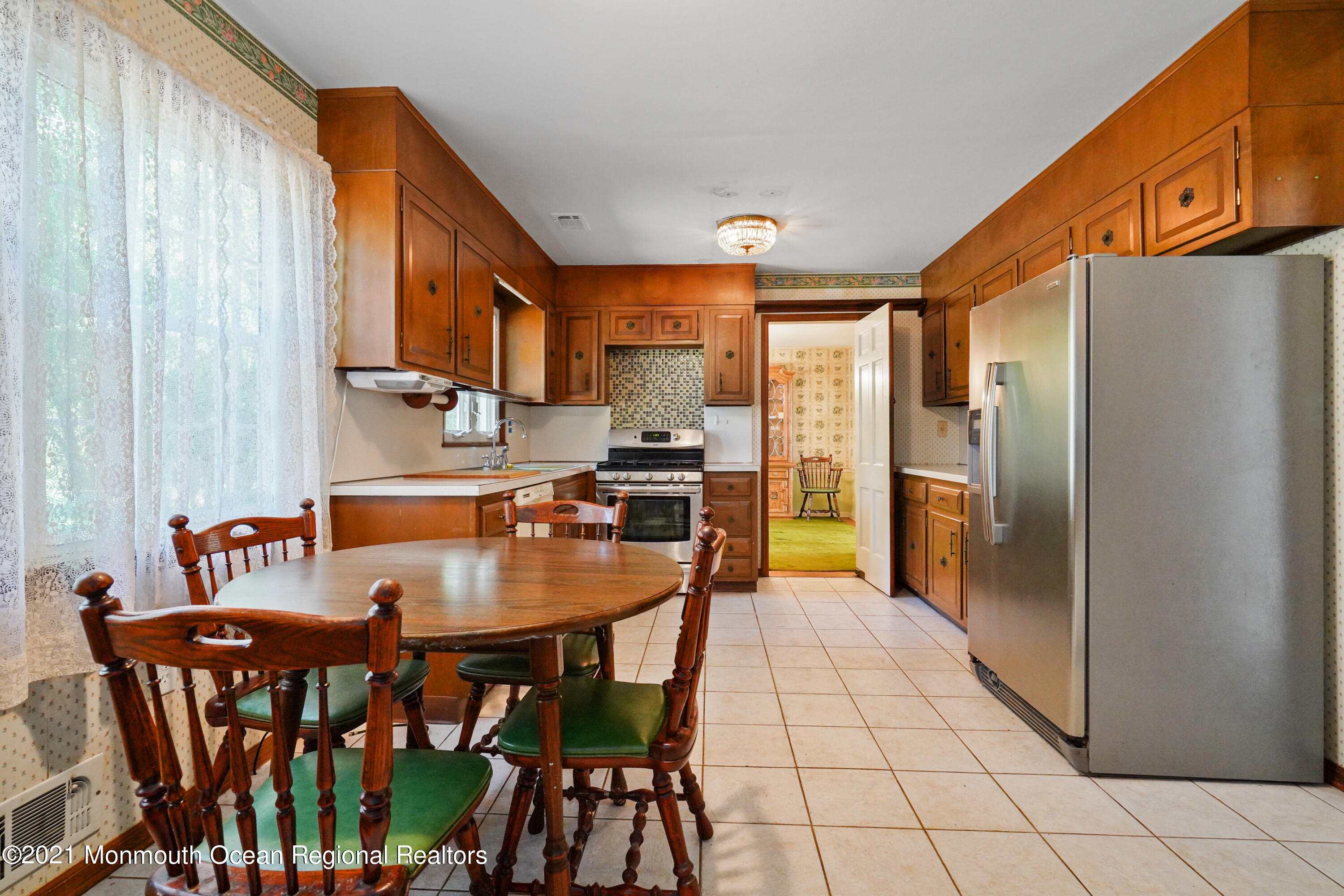 32 Beaver Dam Road Colts Neck, NJ 07722 - Photo 14 of 27 a kitchen with stainless steel appliances granite countertop a refrigerator a stove a sink and a dining table with chairs