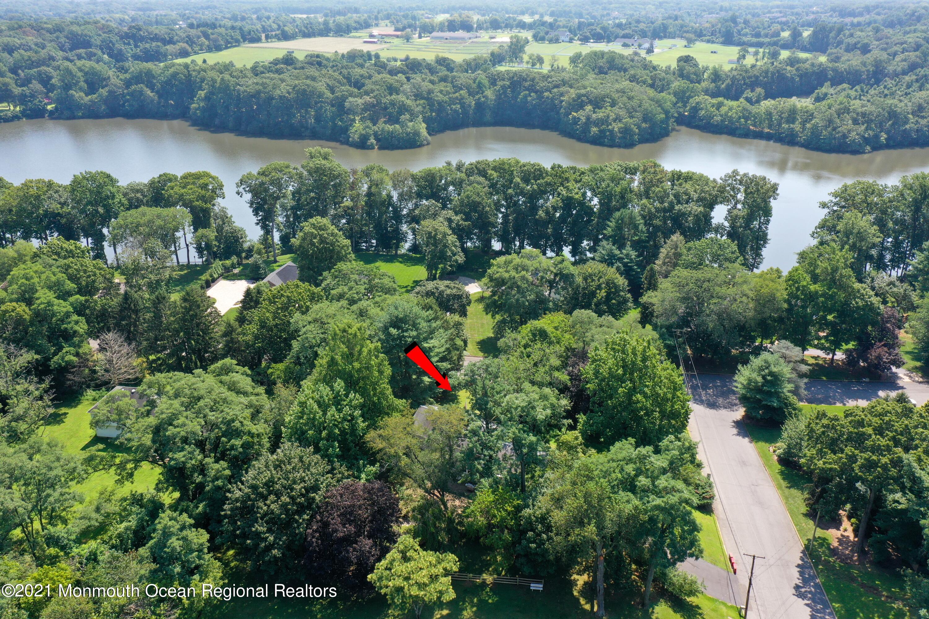 32 Beaver Dam Road Colts Neck, NJ 07722 - Photo 27 of 27 an aerial view of green landscape with trees houses and lake view
