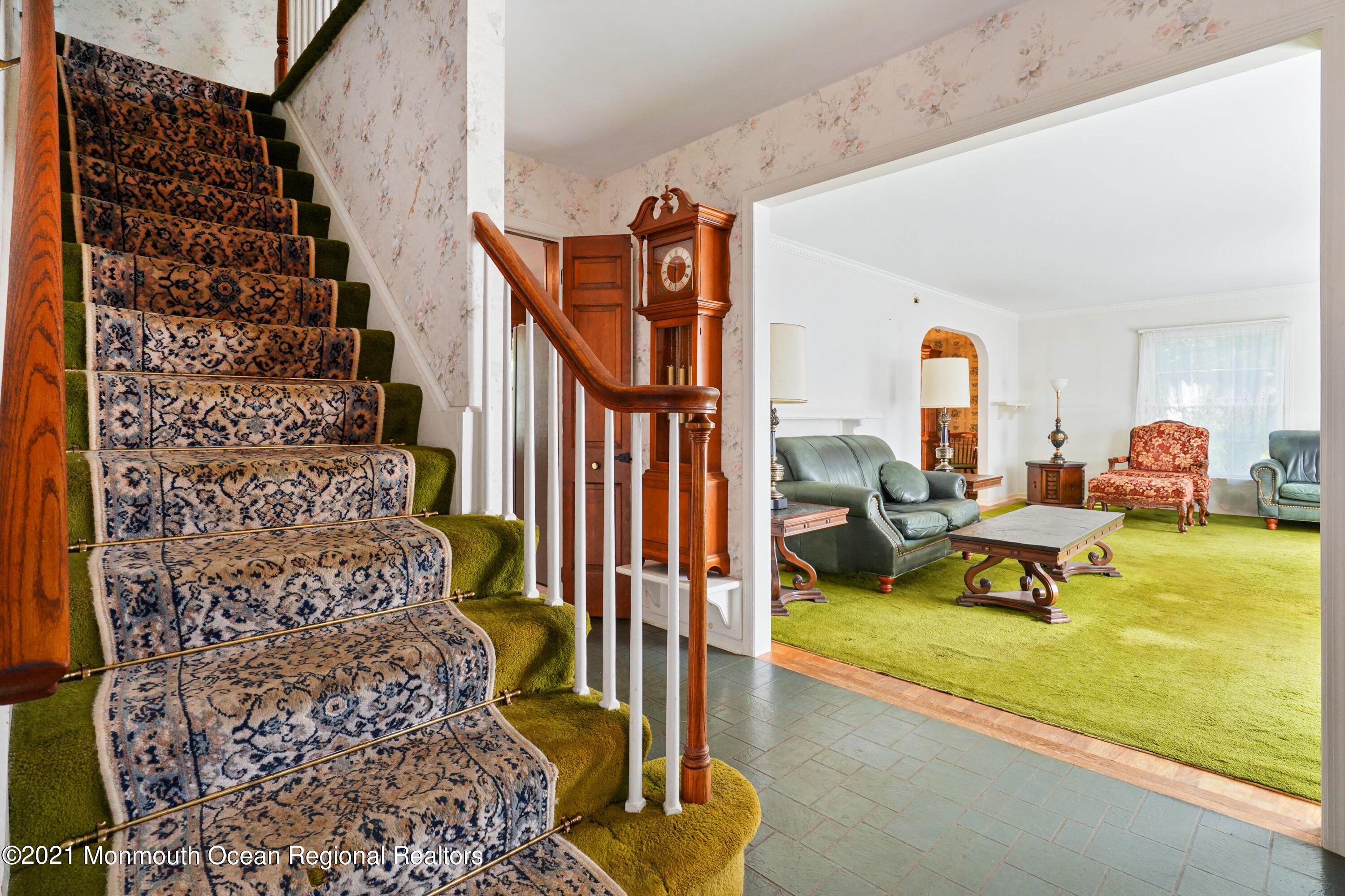 32 Beaver Dam Road Colts Neck, NJ 07722 - Photo 9 of 27 a living room with furniture and a floor to ceiling window