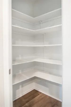 a view of walk in closet with empty racks