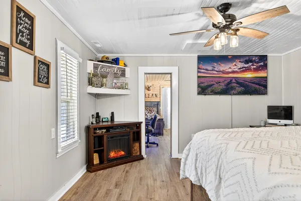 a bedroom with furniture and a wooden floor