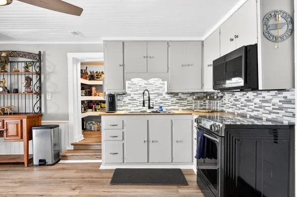 a kitchen with stainless steel appliances a stove microwave and a refrigerator