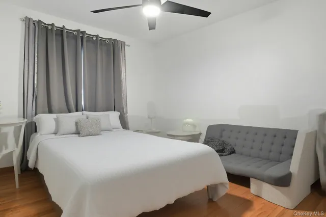 a bathroom with a granite countertop sink a toilet and shower