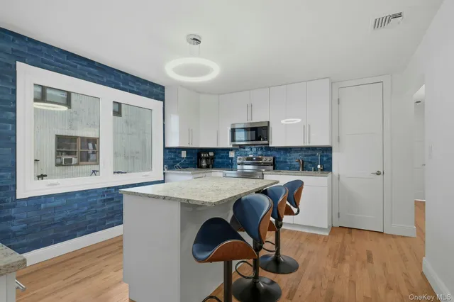 a kitchen with a table chairs refrigerator and cabinets
