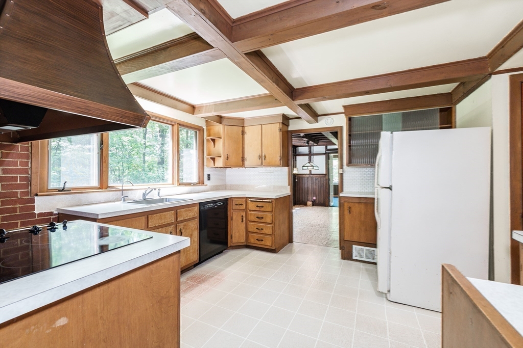 6 Megonko Road Natick, MA 01760 - Photo 13 of 40 a kitchen with stainless steel appliances granite countertop a sink stove and refrigerator