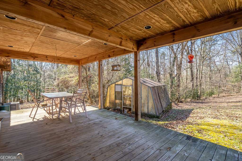 2164 Yukon Road Ellijay, GA 30536 - Photo 11 of 43 a view of a patio with table and chairs and wooden floor