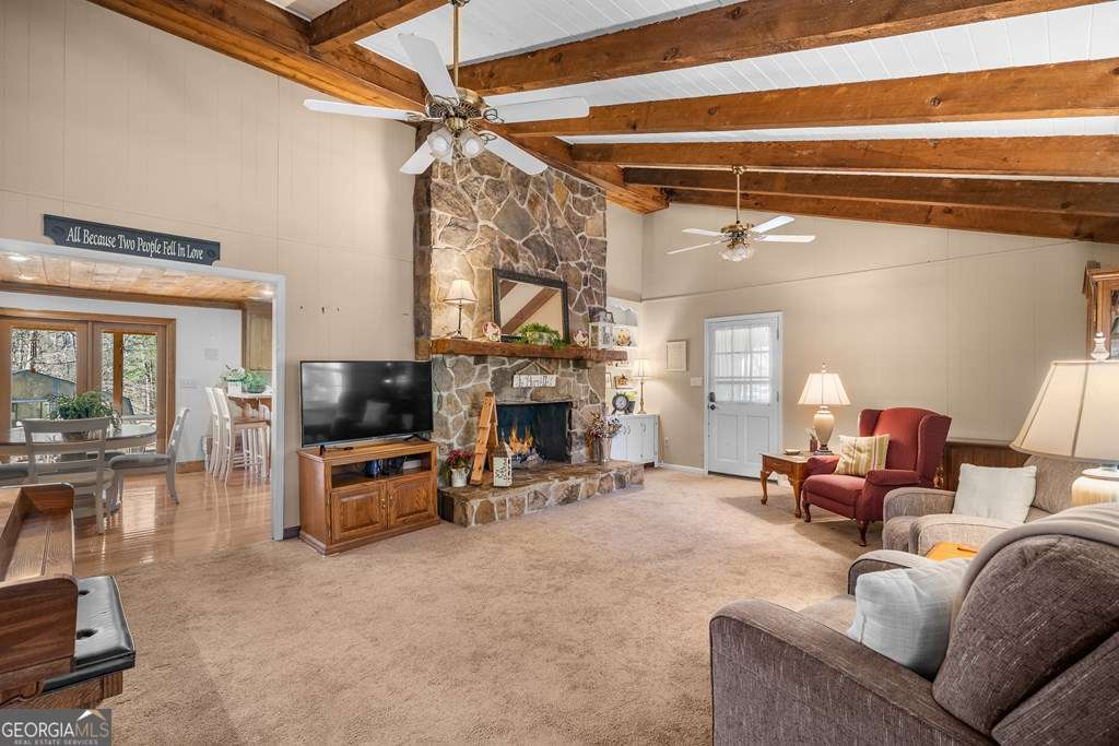 2164 Yukon Road Ellijay, GA 30536 - Photo 19 of 43 a living room with furniture a fireplace and a flat screen tv