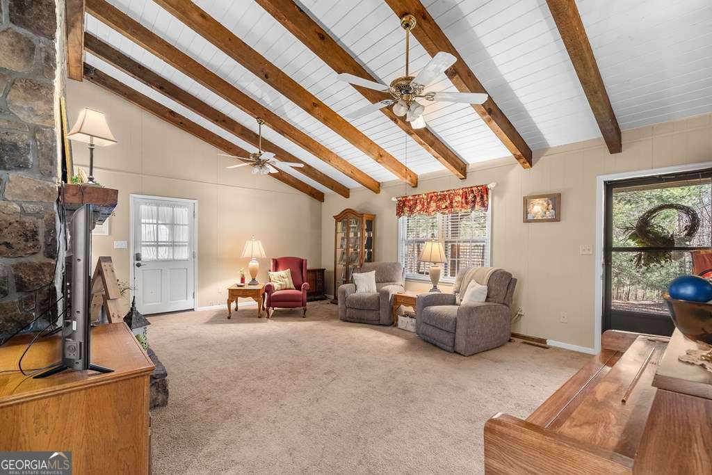 2164 Yukon Road Ellijay, GA 30536 - Photo 20 of 43 a living room with furniture a flat screen tv and a window