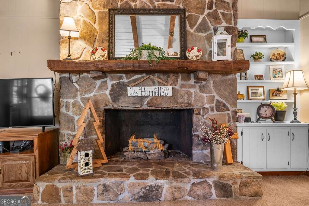 2164 Yukon Road Ellijay, GA 30536 - Photo 21 of 43 a living room with furniture and a fireplace
